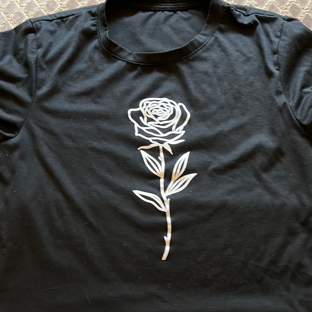 Black T-shirt with white rose on front